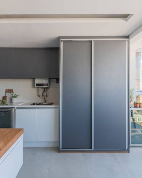 Closet hides laundry room through functional joinery.