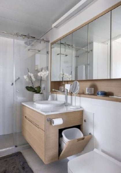 Bathroom with trash inside the cabinet.