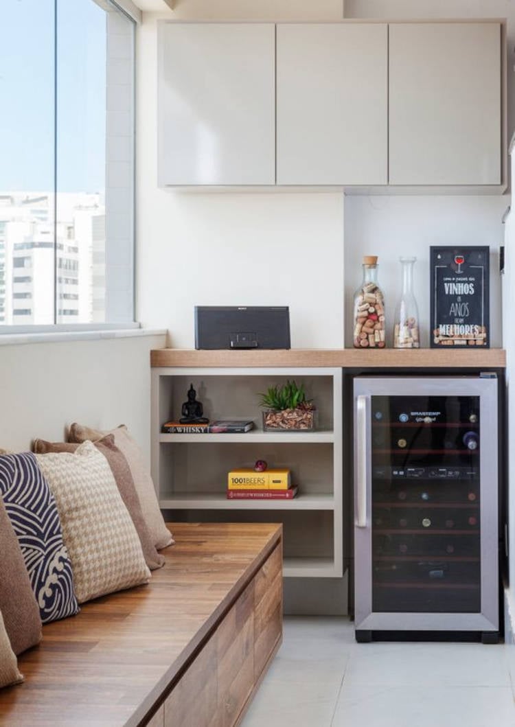 Balcony with bench and wine cellar.