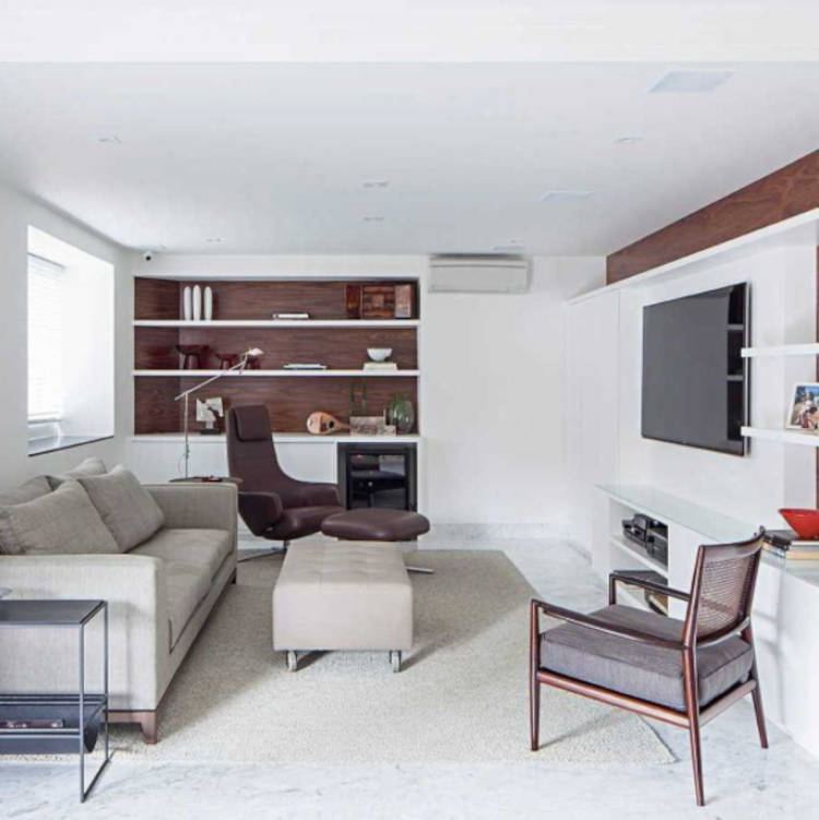 Living room with neutral tones and air conditioning.