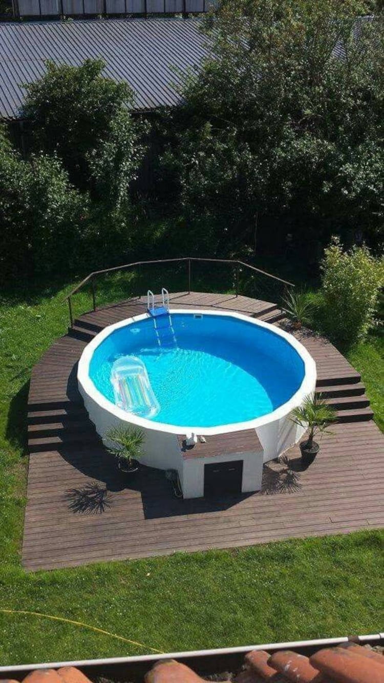 Large wooden deck for a round pool.