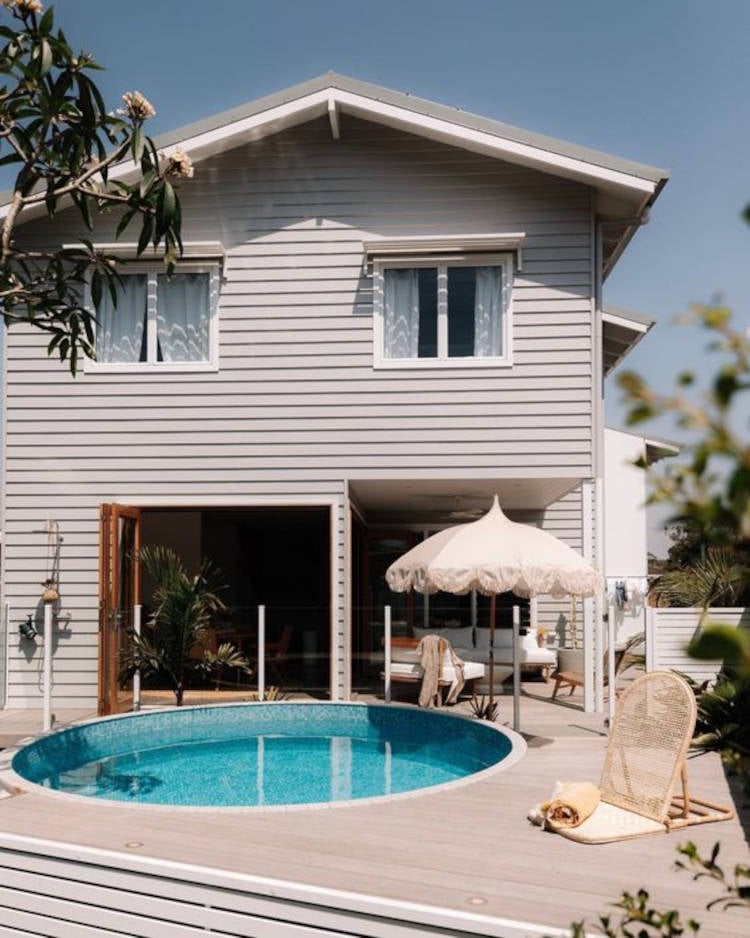 Round pool deck in two-story house.