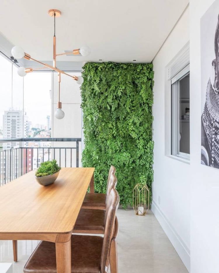 Balcony with wooden table and garden.