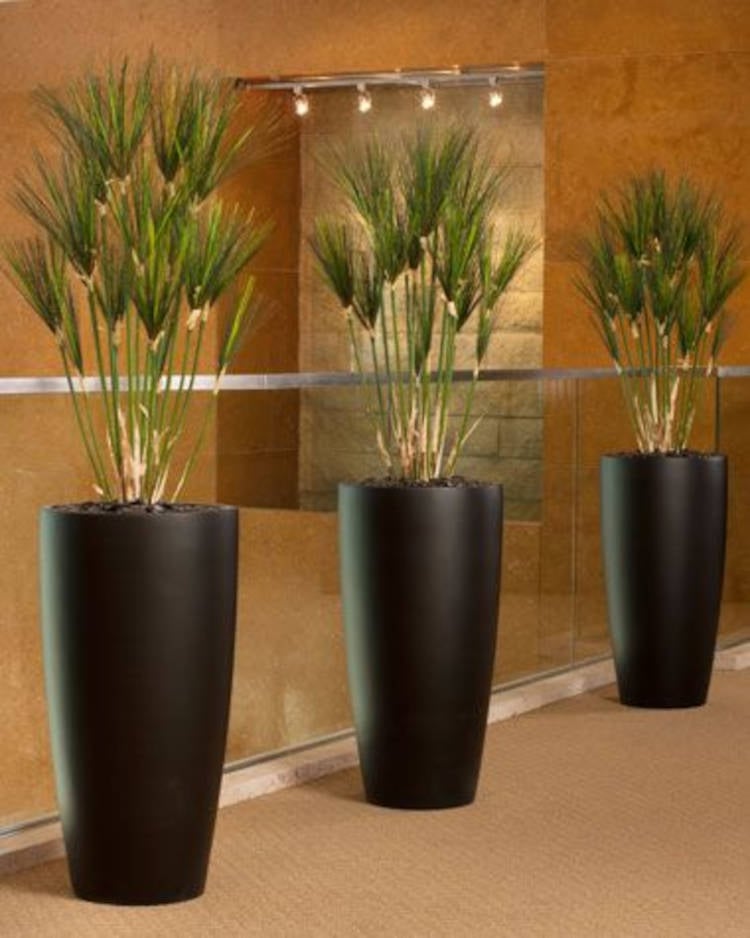 Hallway decorated with artificial plants.