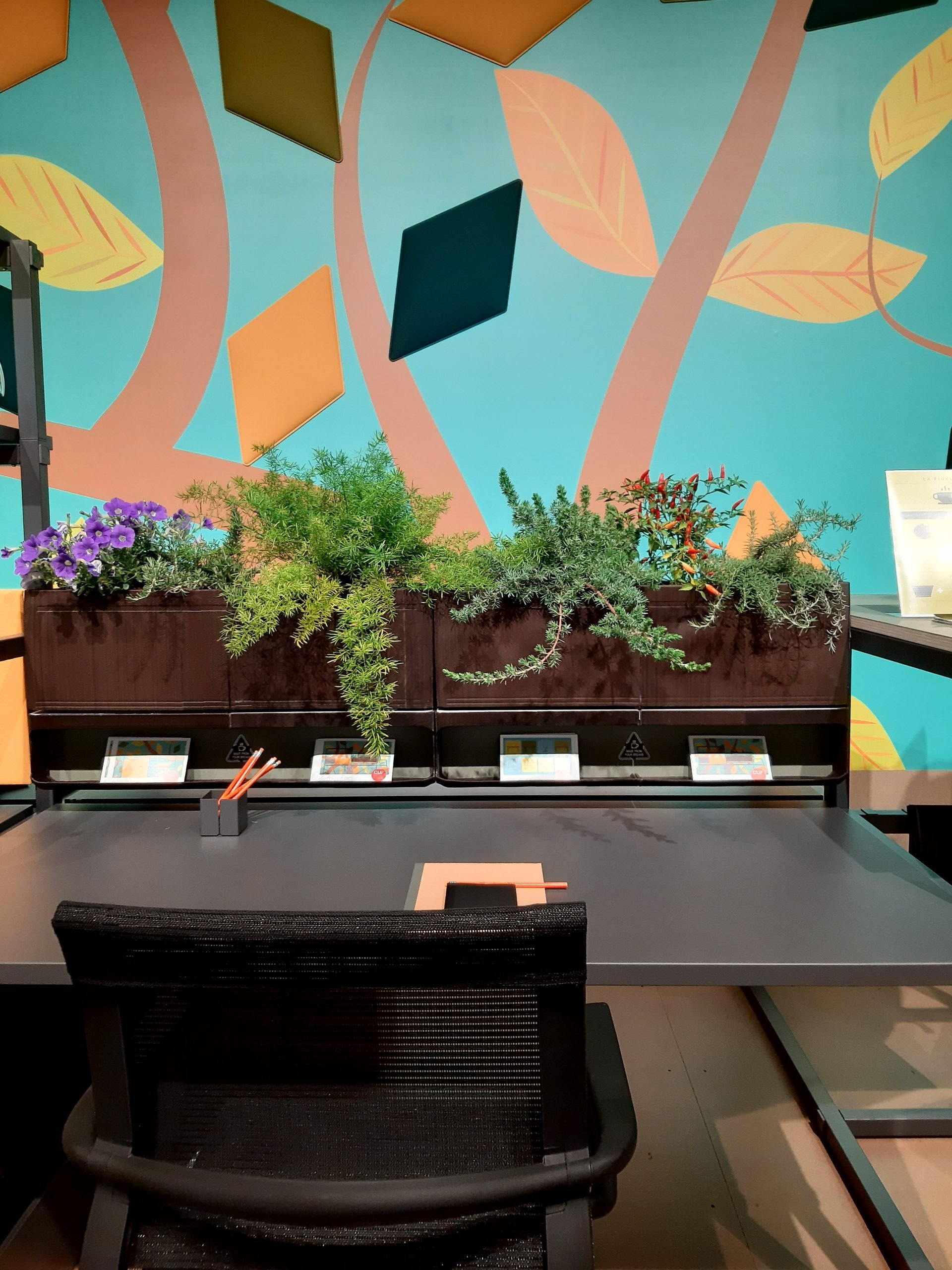 Home office proposal with natural plant planter at the top of the station and ergonomic chair