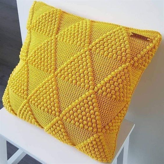 Yellow crochet pillow.