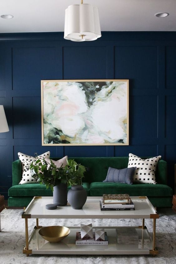 Navy blue wall with painting.