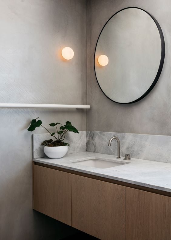 Bathroom with round mirror.