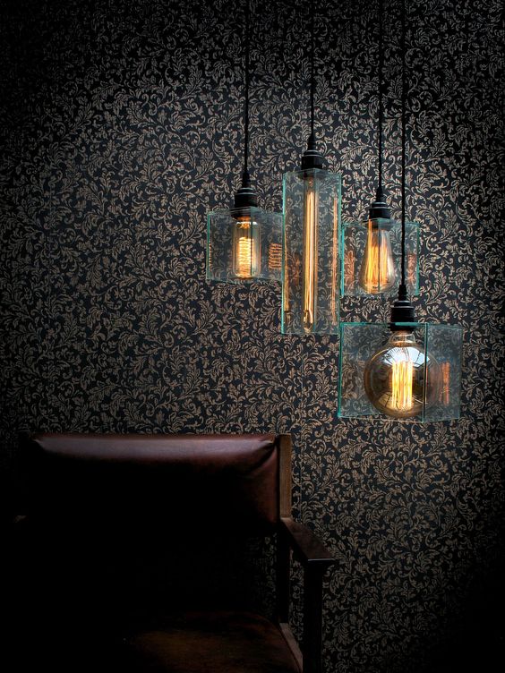 Dark room with four suspended lamps.