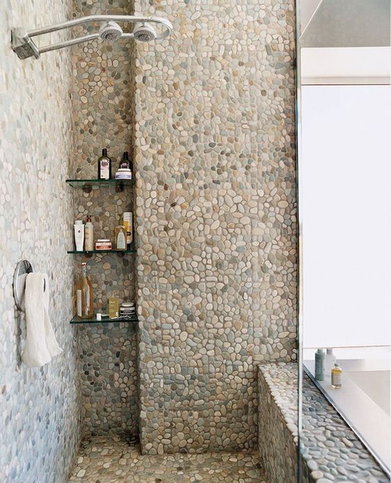 Bathroom with pebbles in the shower.