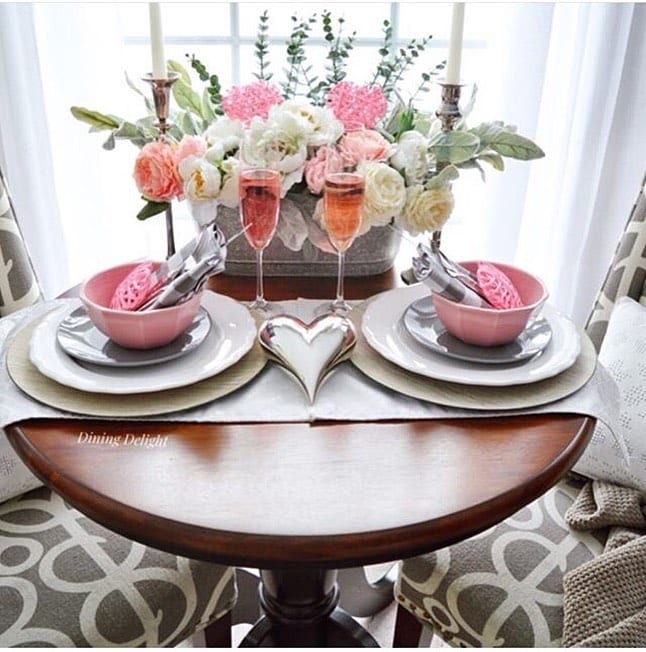 Valentine's Day dinner table decorated with silver heart and pink and white roses