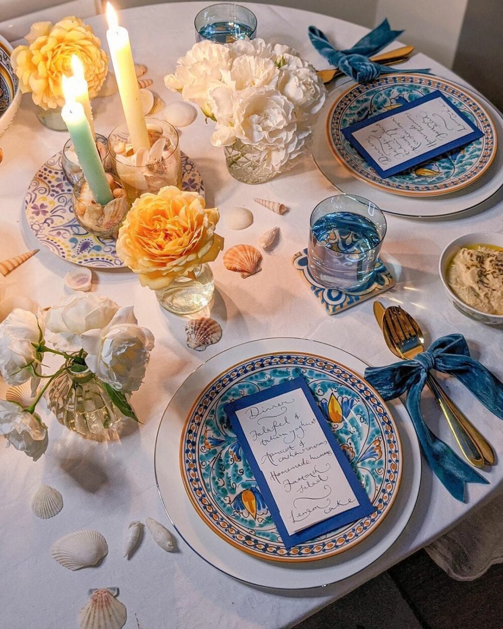 Table set for a romantic dinner with blue and yellow decor