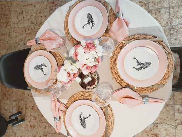 Romantic dinner with a table set decorated in light pink tones - delicacy