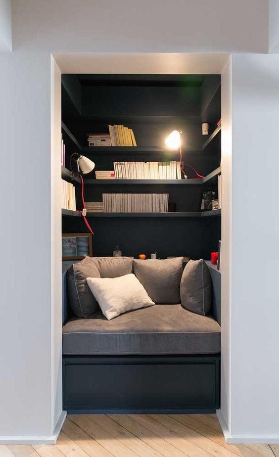 Small room with books and sofa.