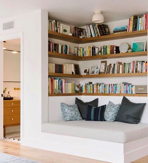 Sofa bed under shelves.