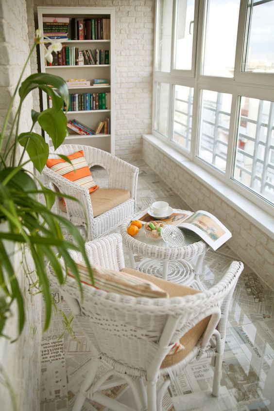 Two chairs and table on the balcony.