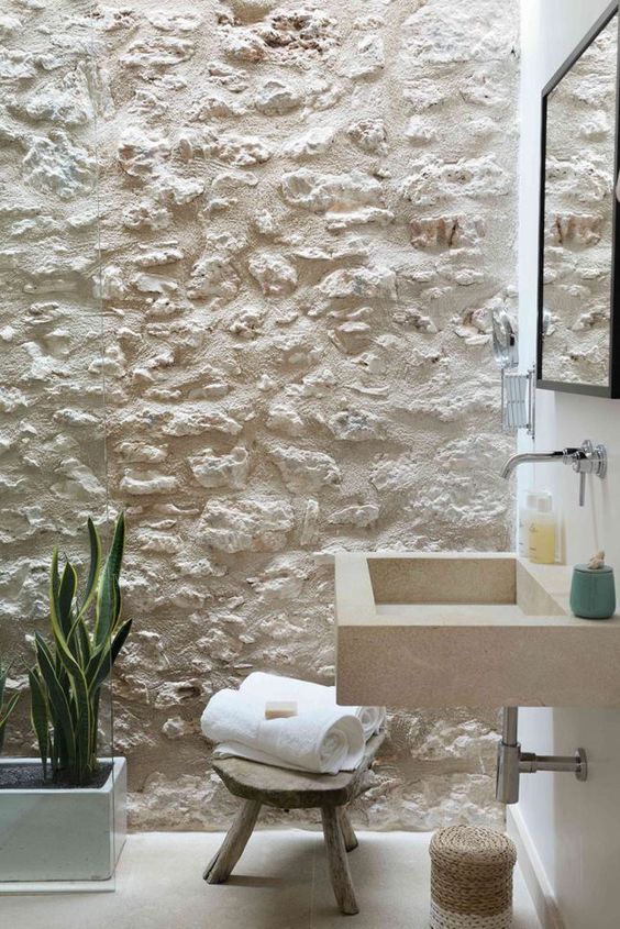 Bathroom with white stone wall.