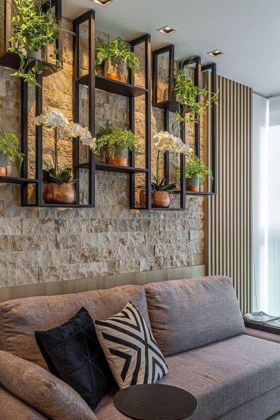 Room with stone wall and plants.