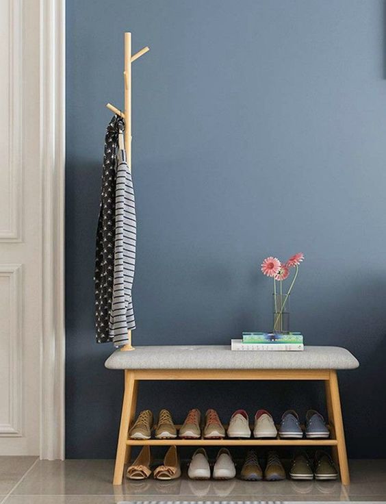 Blue wall with shoe rack.