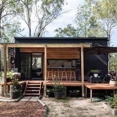 Container house with wooden deck.