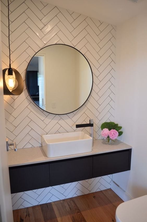 Minimalist bathroom with round mirror