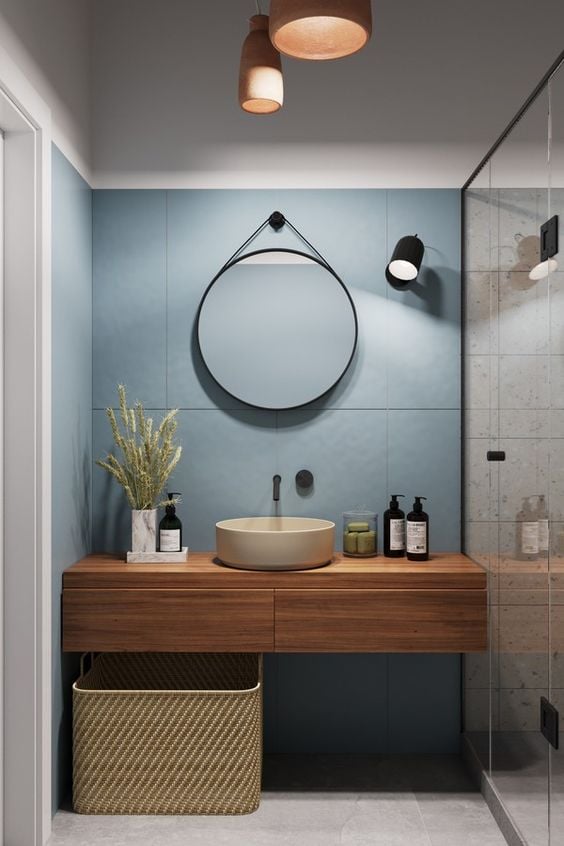 Blue wall with round mirror