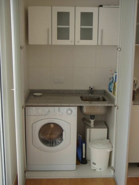 Simple hidden laundry room.