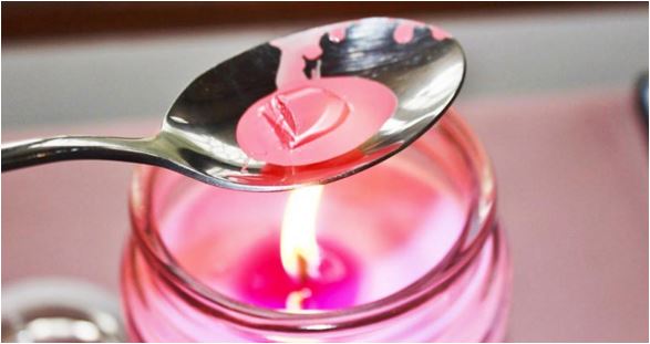 Melting crayons on a spoon using a candle