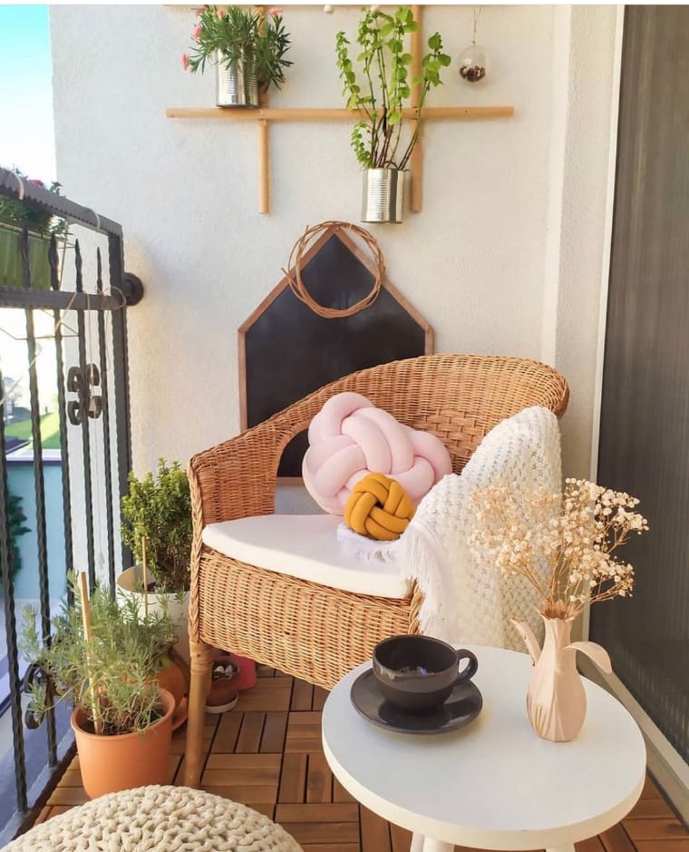 Balcony with armchair and table.