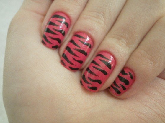 hand with animal print decorated nails