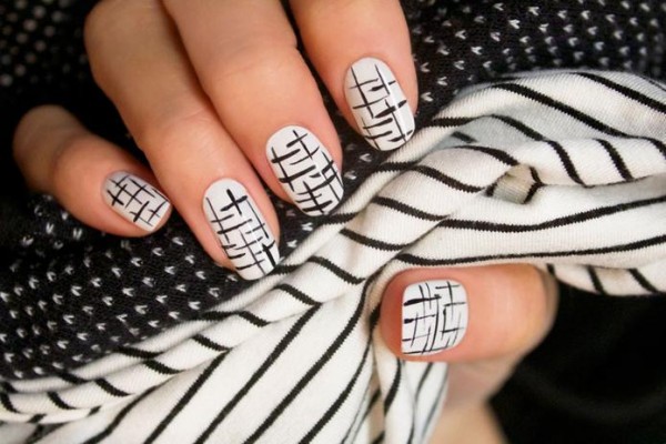 Photo of a nail decorated with black stripes