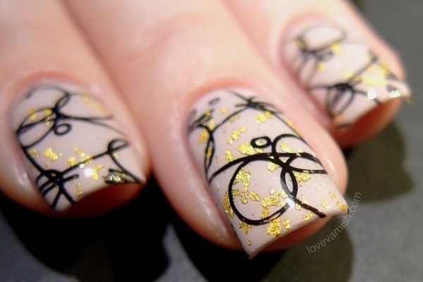 Photo of black and gold decorated nails