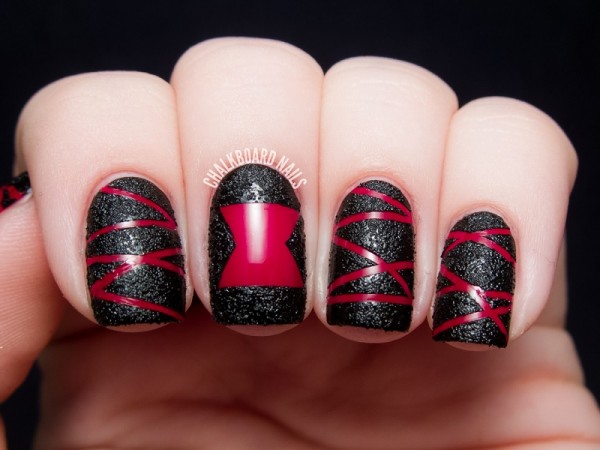 nail decorated with black and red nail polish