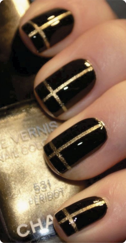 nails decorated with black gold thread and gold