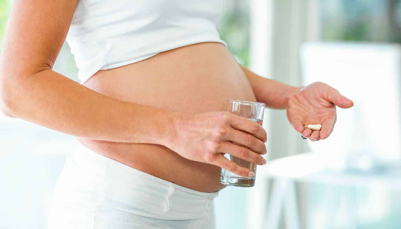 pregnant woman taking medicine