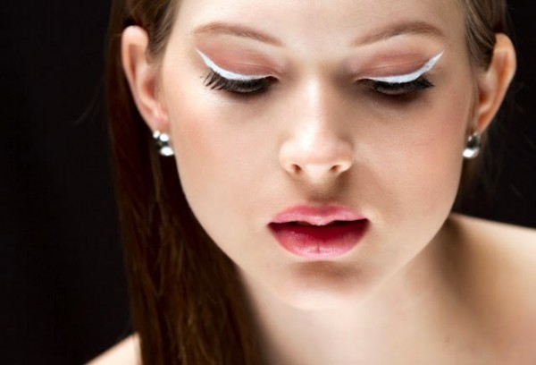 Girl using white eyeliner