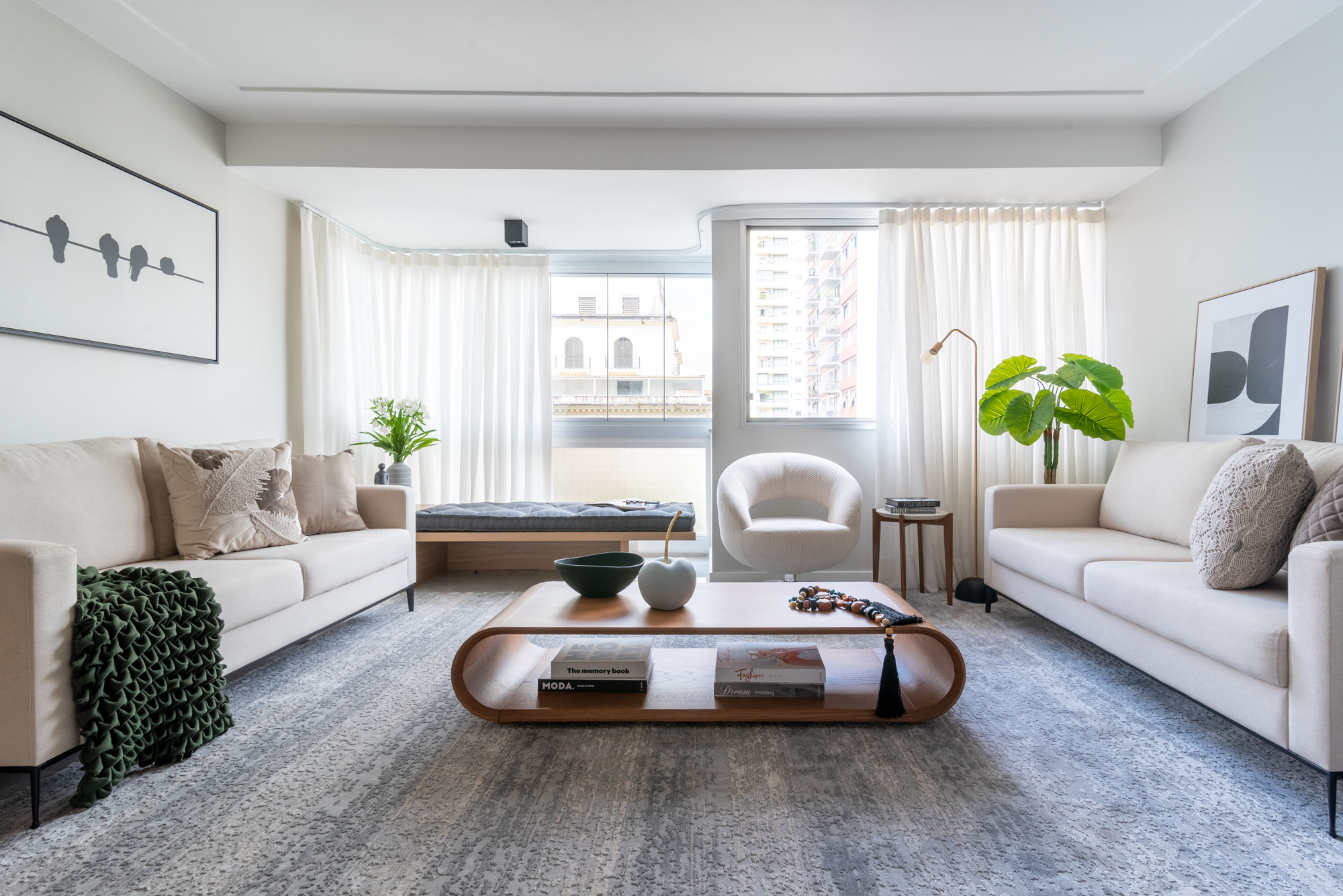 Living room with white sofas, wooden coffee table and gray rug