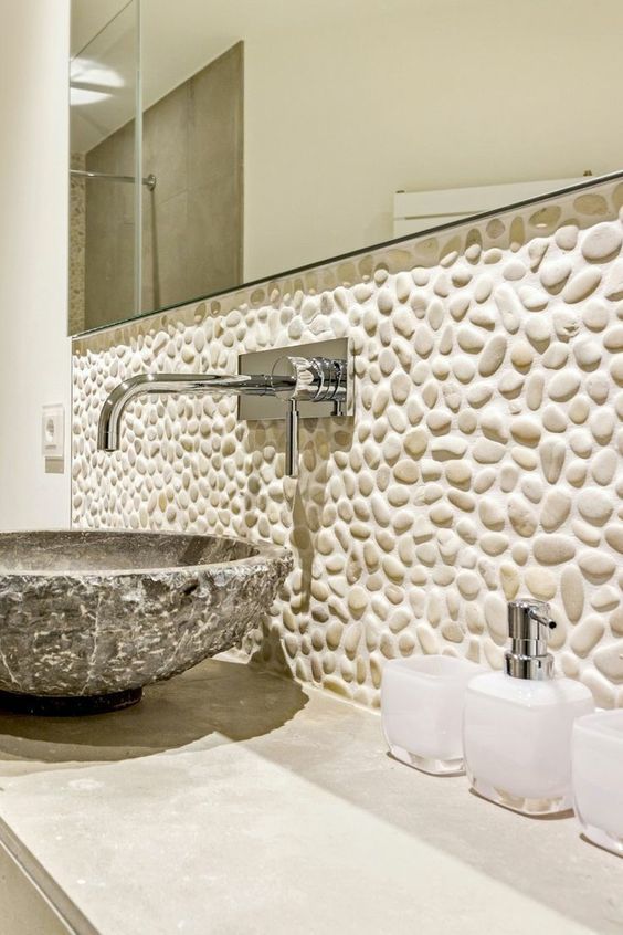 Bathroom with pebbles above the sink.