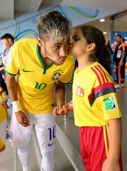 Neymar gets a kiss from a child fan