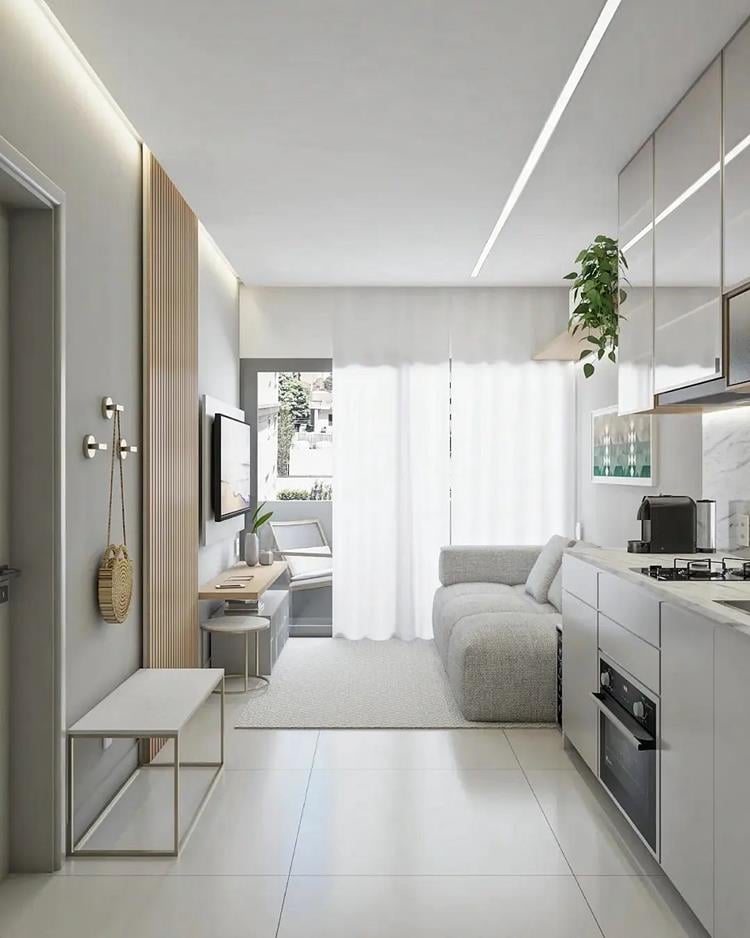 photo of integrated kitchen and living room in a small apartment in light tones