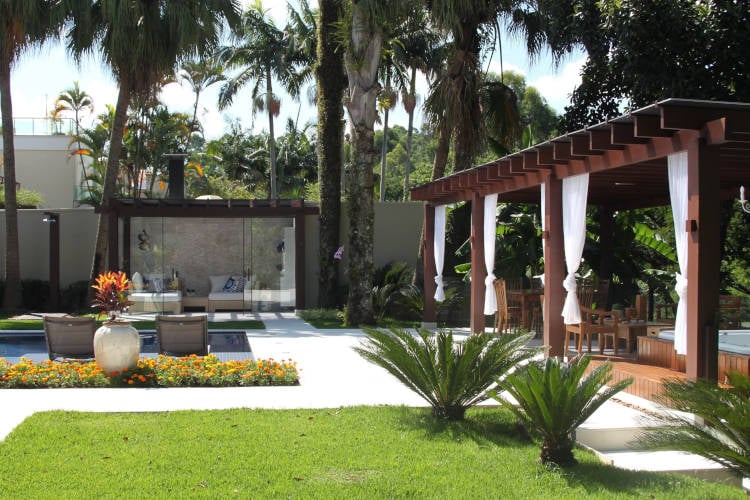 Farming area with pool, grass and wooden pergola.