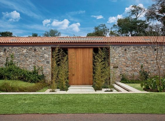 Facade with stone wall and wooden door.