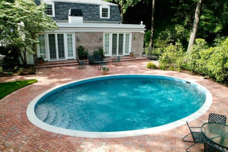 Round pool deck with stone.