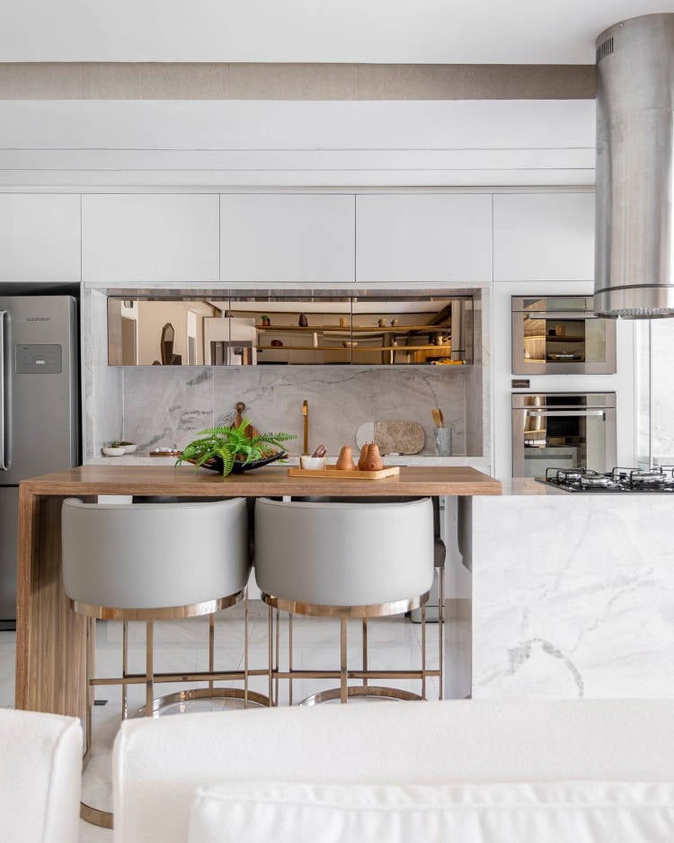 White kitchen with wooden island.