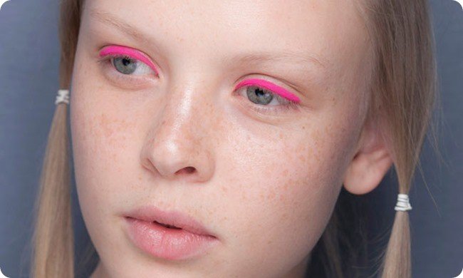 photo of girl wearing pink eyeliner