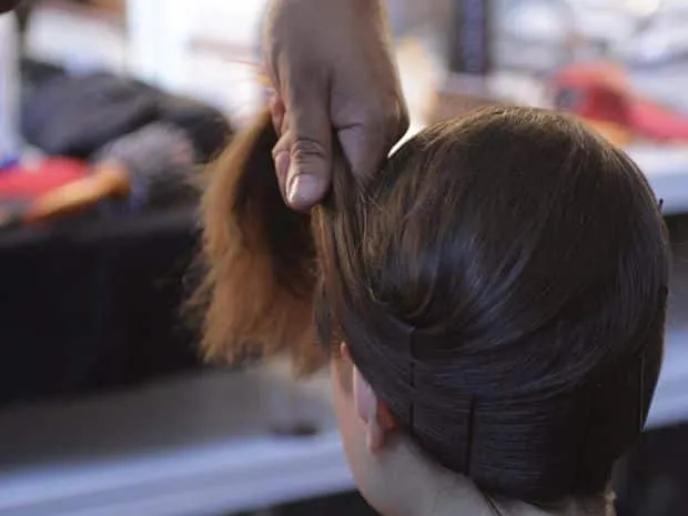 Hair tied in clips for hair straightening technique