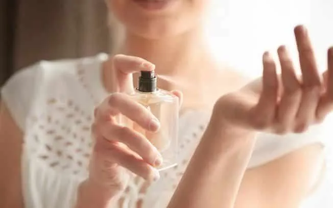 woman applying perfume