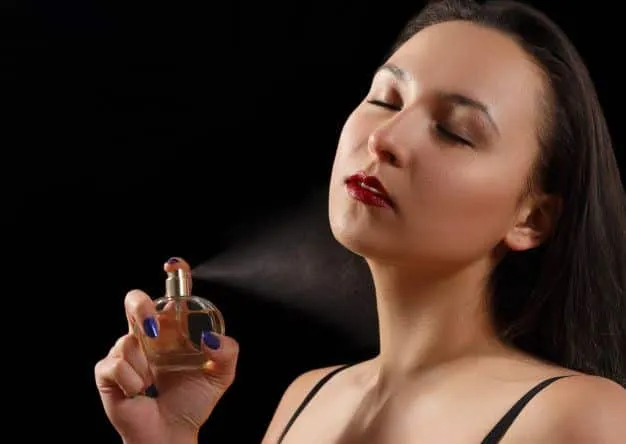 woman applying perfume