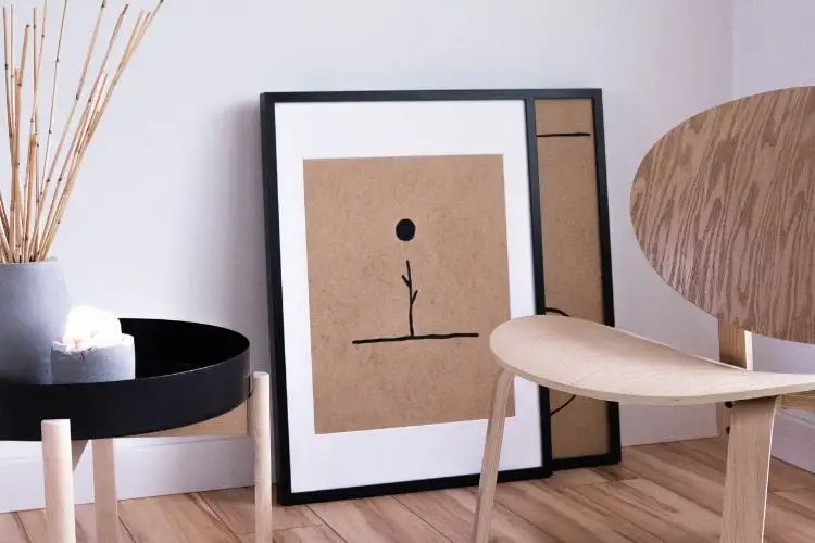 Scandinavian decor with wooden chair, dining table, round black frames on the floor